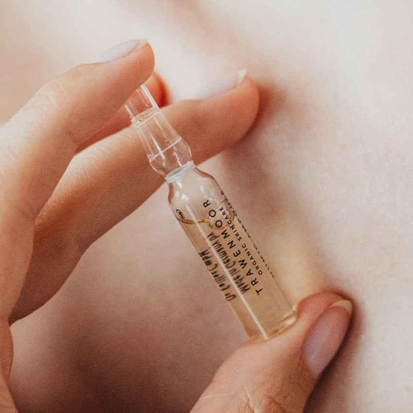 Woman holding Trawenmoor ampoule with two fingers
