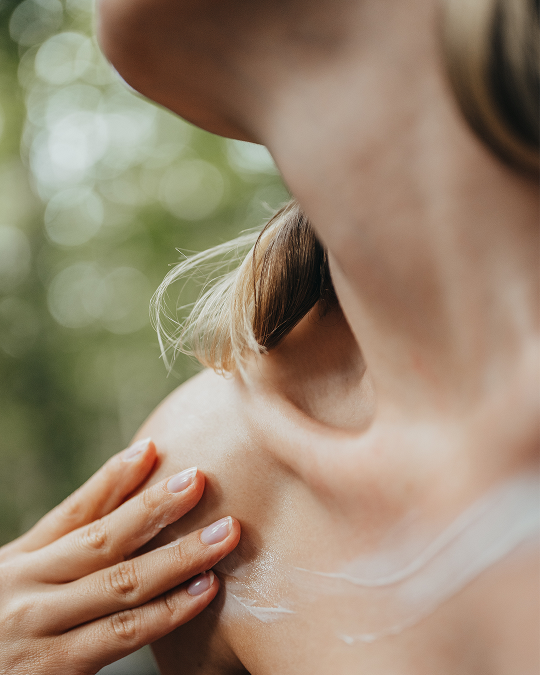 Woman with cream on decolette